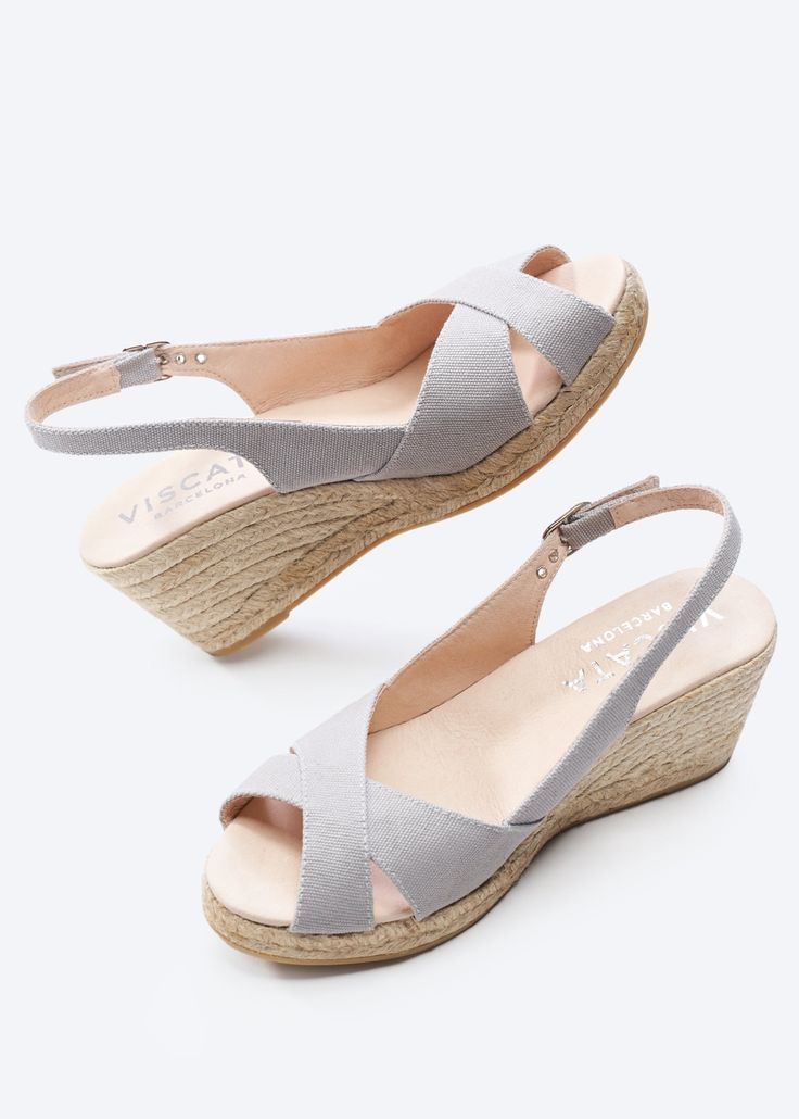 These stylish and flirty Llansa canvas wedges have a flattering slingback heel, an elegant buckle and soft cotton, 100% organic canvas for a comfortable, luxurious fit. And with a gorgeous 2 ½” heel, they’re comfortable enough to get you from sunny days to stylish nights. TOP TIP: STYLING Sexy and stylish, these handmade espadrille wedges feature eco-friendly jute soles for natural breathability, the perfect party shoes for those hot summer evenings. TOP TIP: SIZING If you are an in-betweener tr Medium Wedges, Sandal Wedges, Sell Shoes, Comfortable Wedges, Wedge Espadrilles, Mens Uggs, Platform Slippers, Slingback Heel, Espadrille Sandals