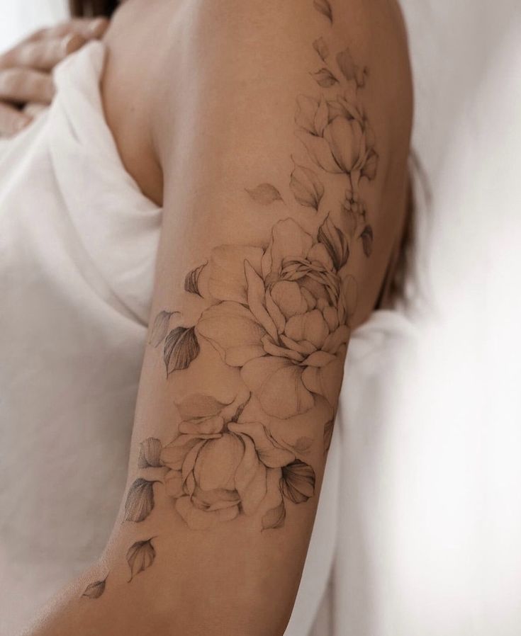 a woman with a flower tattoo on her arm