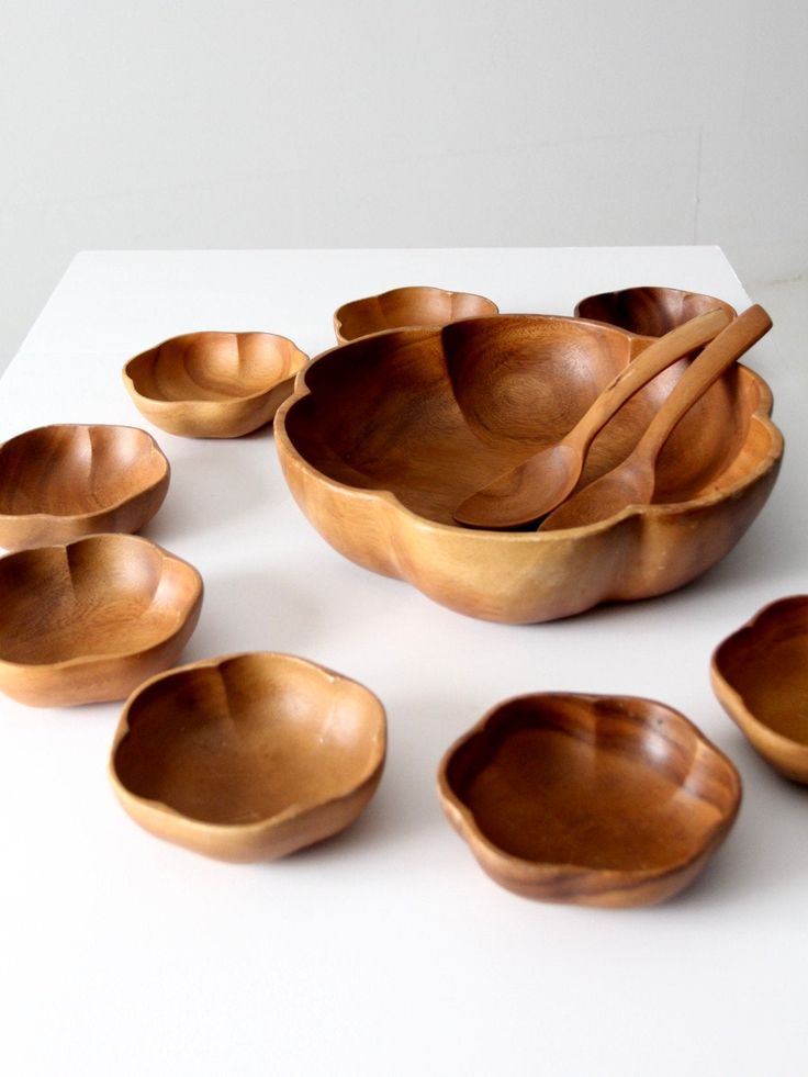 wooden bowls and spoons on a white surface