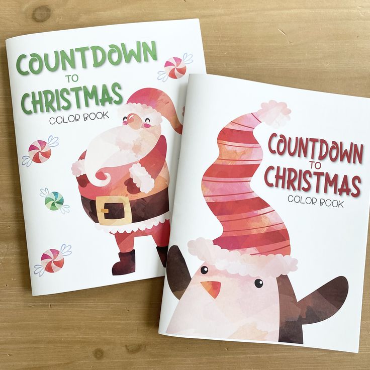 two children's books with santa claus and snowman designs on them sitting on a wooden table