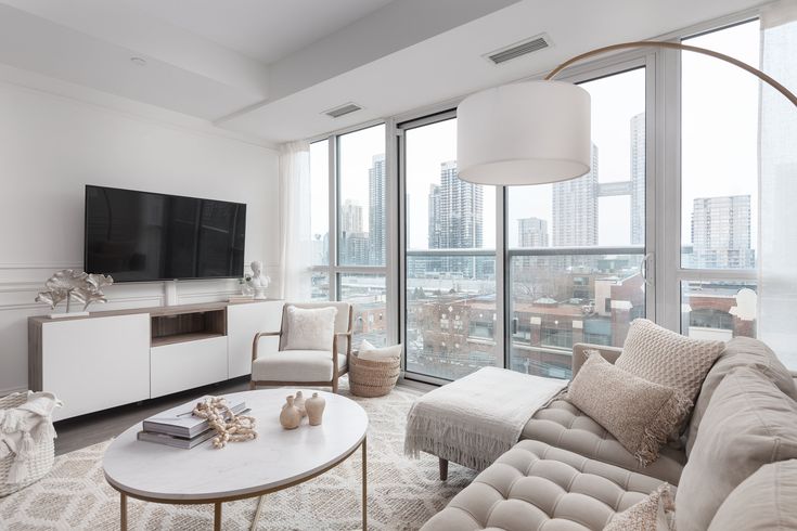 a living room filled with furniture and a flat screen tv on top of a wall