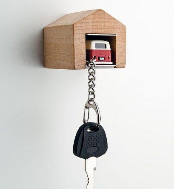 a house shaped key holder with a phone attached to it