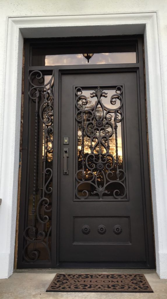 the front door is decorated with wrought iron