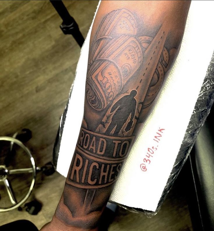 a man with a tattoo on his arm that reads road to riche