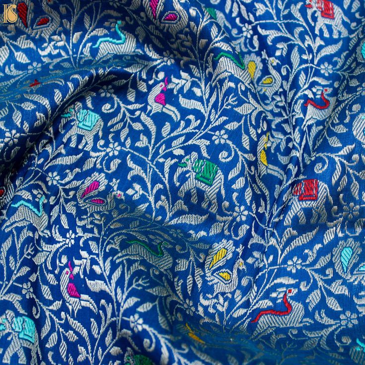 blue and white fabric with colorful designs on it