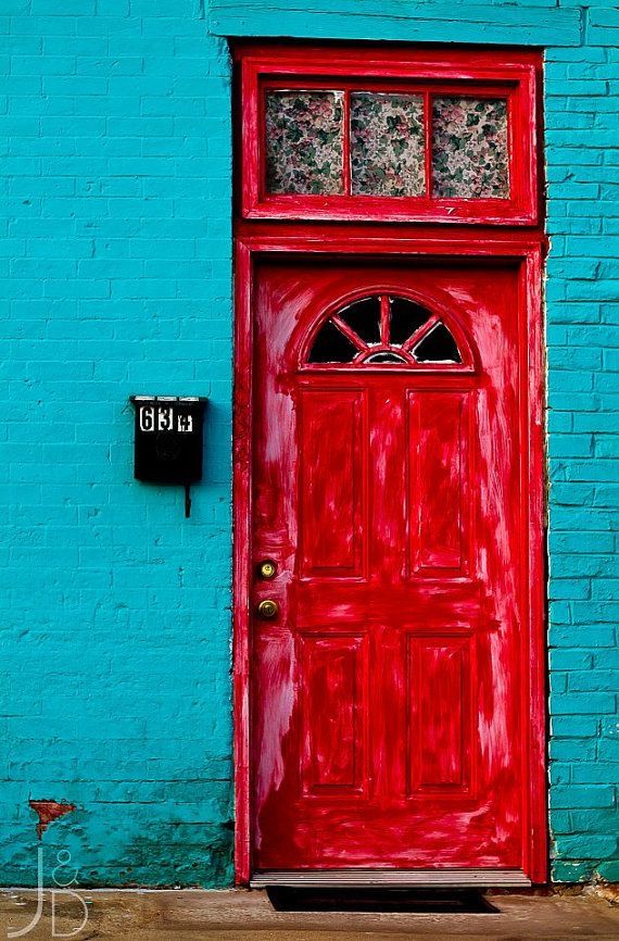 a red door is in front of a blue wall