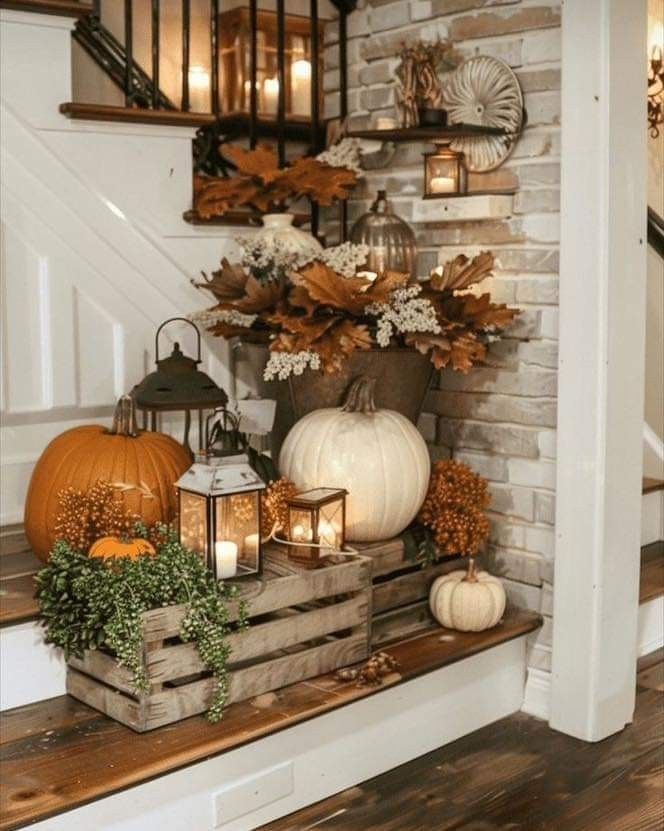 some pumpkins and candles are sitting on the stairs