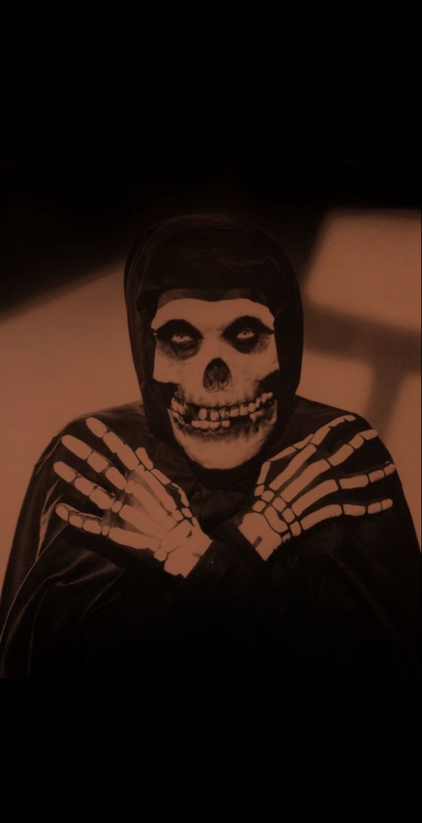 a man in a skeleton costume with his hands crossed