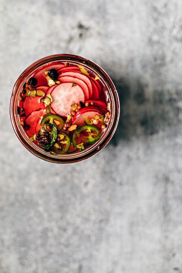 pickled radishes in a mason jar with the words adding quick pickled radishes