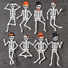 paper cut out skeletons with hats and bows on their heads are arranged in the shape of people