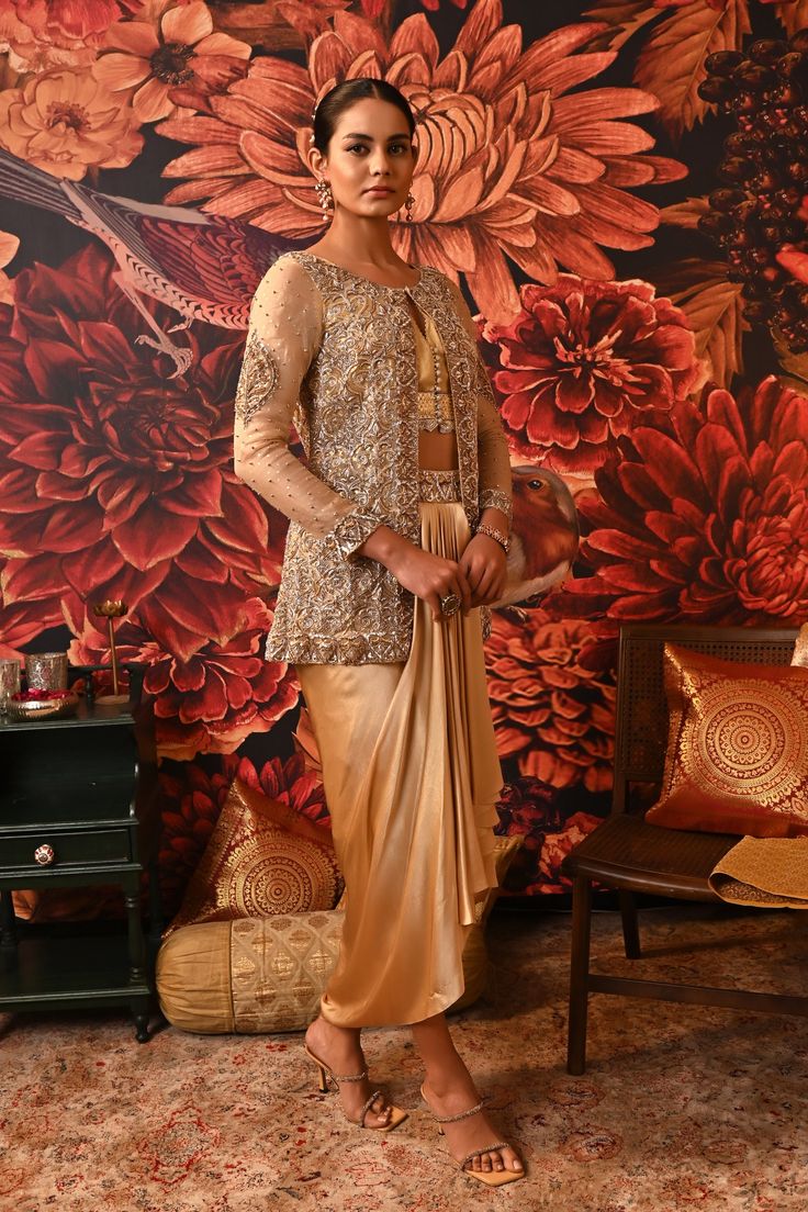 This Gold Co-ord set is the way to hop on the bold and versatile trend, that modern women prefer. Paired with a waistcoat style top along with a heavily embroidered jacket detailed with silver and golden hue and for the bottom a dhoti-style draped skirt giving you that chic regal look. Gold foil printed sleeveless blouse with embroidered border and handmade buttons on the centre front Front Open jacket with gold foil print heavily embellished with dabka & nakshi Waistcoat style bustier Dhoti-sty Waistcoat Style, Handmade Buttons, Embroidered Belt, Open Jacket, Embroidered Border, Printed Sleeveless Blouse, Draped Skirt, Gold Foil Print, Modern Women