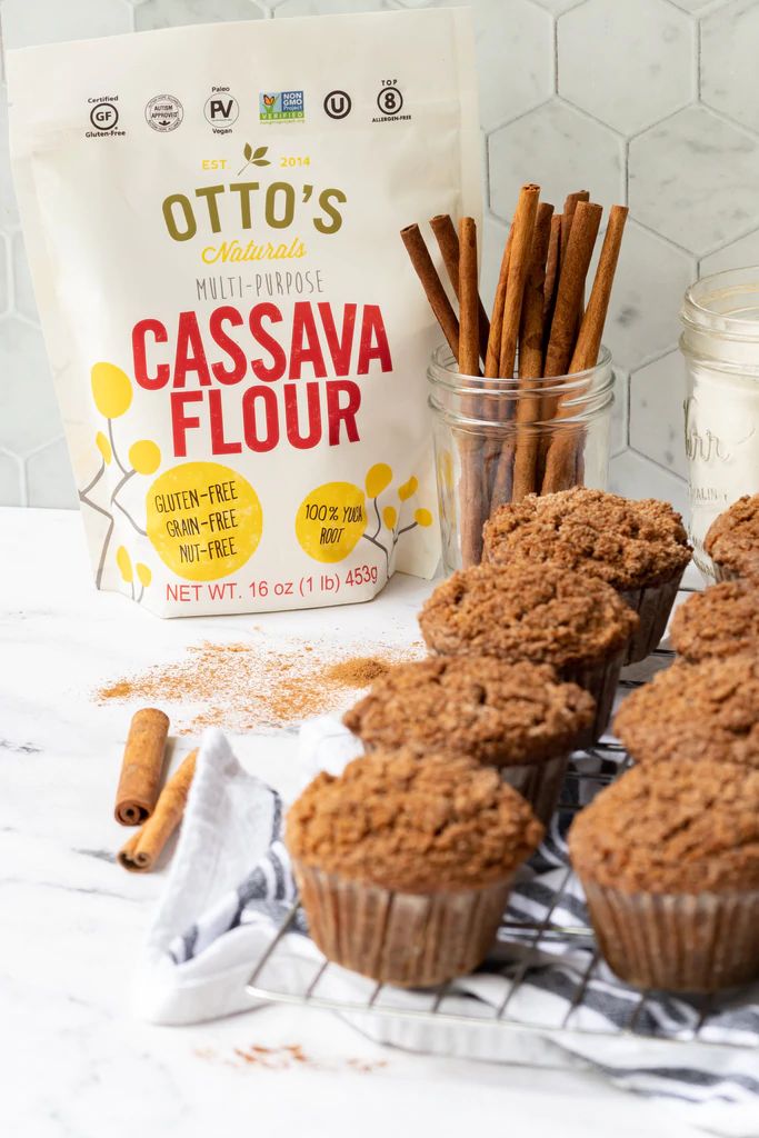 cinnamon muffins on a cooling rack next to a bag of cassava flour