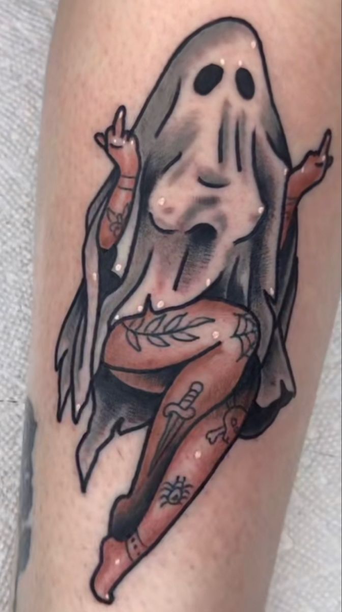 a person with a ghost tattoo on their leg