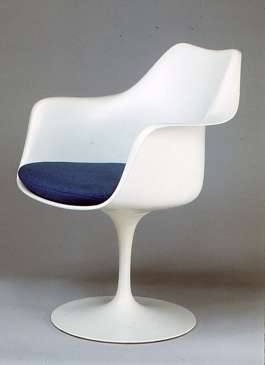 a white chair with a blue cushion on it's seat and the back side