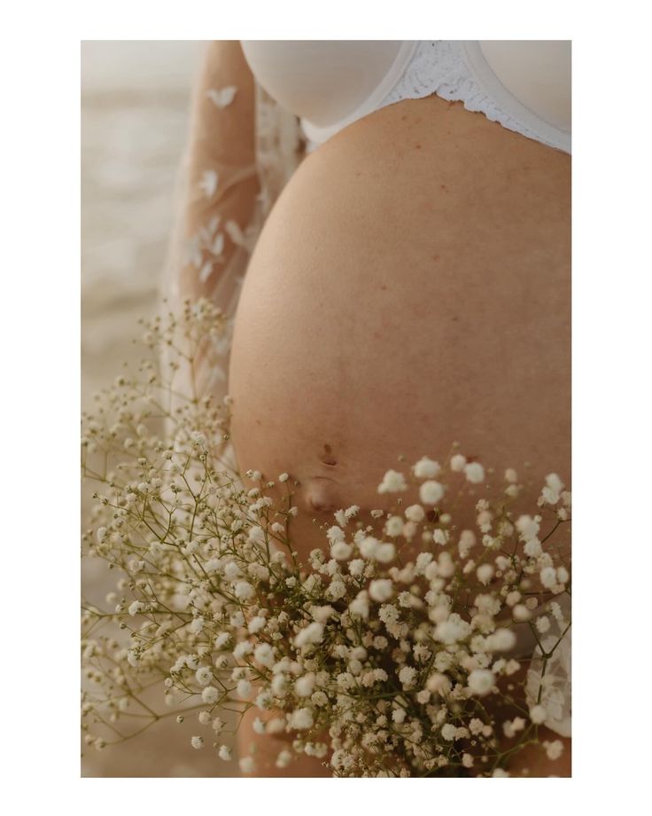 a pregnant woman with flowers in her belly