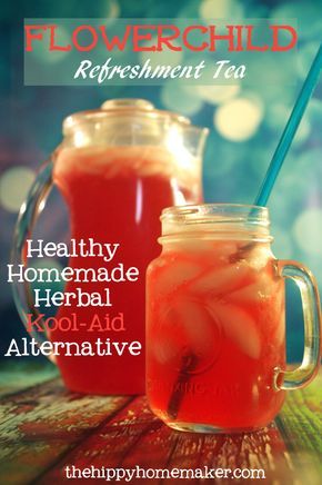 two mason jars filled with red liquid sitting on top of a table next to each other