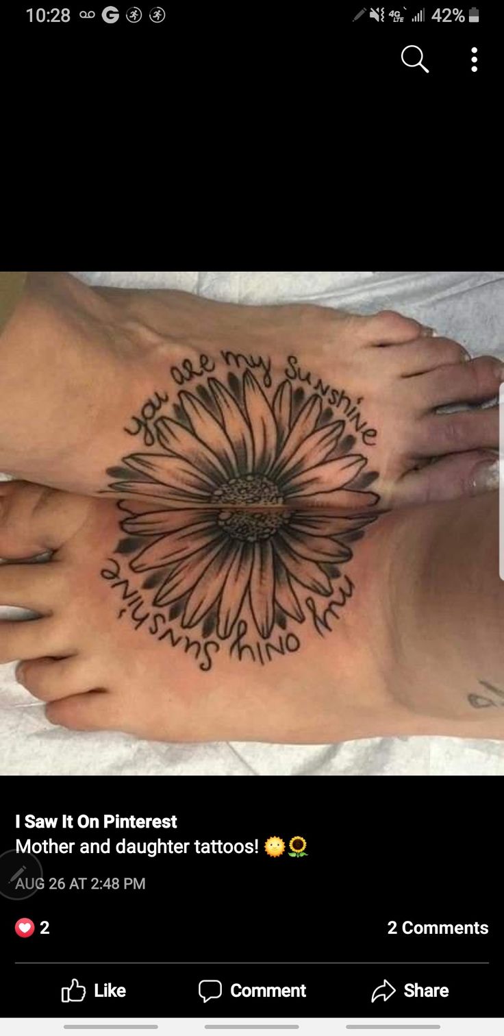 two feet with tattoos on them and one has a flower in the middle of it