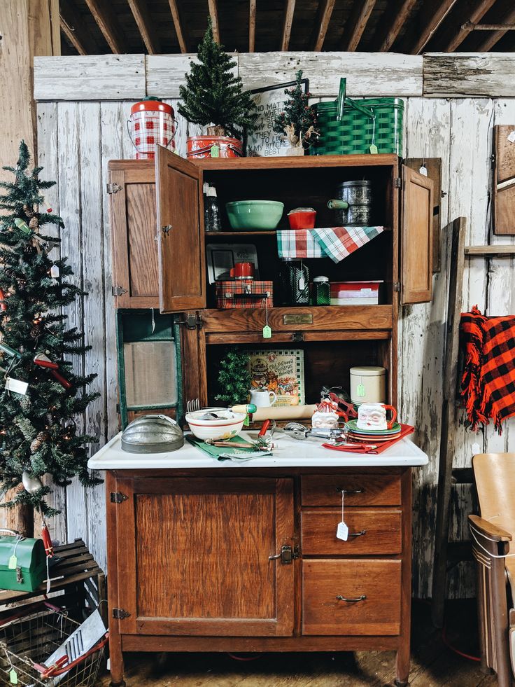 an old fashioned kitchen with christmas decorations on the shelves