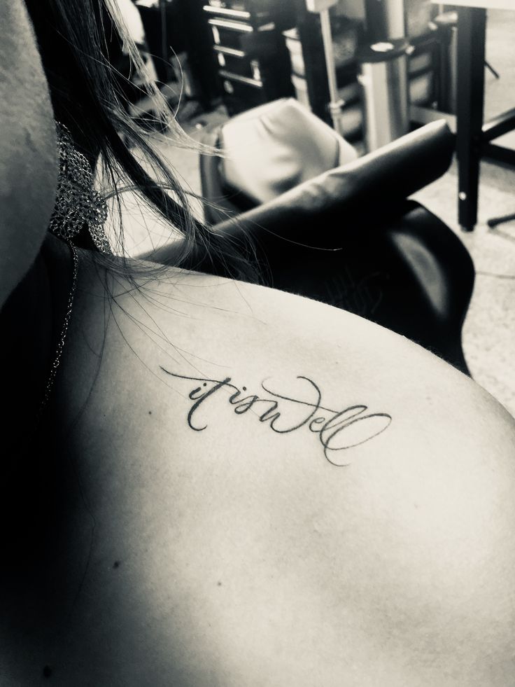 the back of a woman's shoulder that says sorry on her left side, and is in black and white