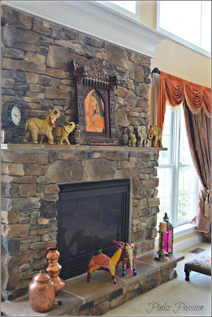 a stone fireplace with figurines on the mantle