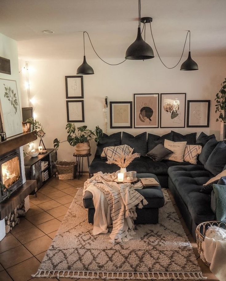 a living room filled with lots of furniture next to a fire place in a fireplace