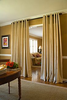 a living room filled with furniture and curtains