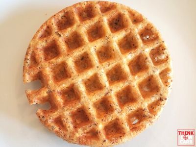 a waffle sitting on top of a white plate