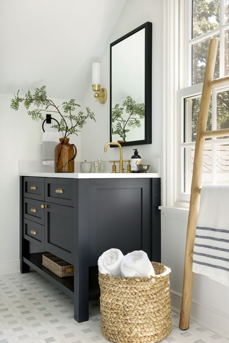 a bathroom with a large mirror, sink and wooden ladder in front of the window