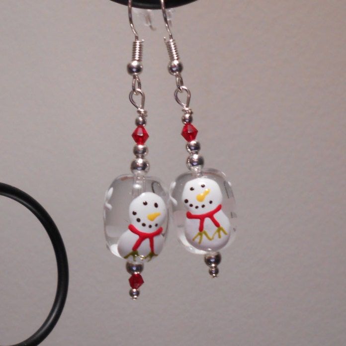 Earrings are hand-crafted by Joyce. These earrings are fun to wear and add some charm and beauty to your wardrobe.  The front has a snowman on the front and snowflakes on the back. These pairs of earrings were created using glass beads and glass seed beads on nickel-free wire and come with earring backs so they will never fall out! Orders usually ship within 1-2 days and there is only one charge for shipping, no matter how many items you choose to purchase! Please contact me if you have any questions! These earrings are handmade and unique so I will do my best to tailor to your preferences. Let me know if you would like a different color and style and if I can I will gladly accommodate. Snowman Earrings, Little Earrings, Glass Snowman, Winter Earrings, Swirl Earrings, Holiday Earring, Orange And Turquoise, Earrings Red, Swarovski Crystal Earrings