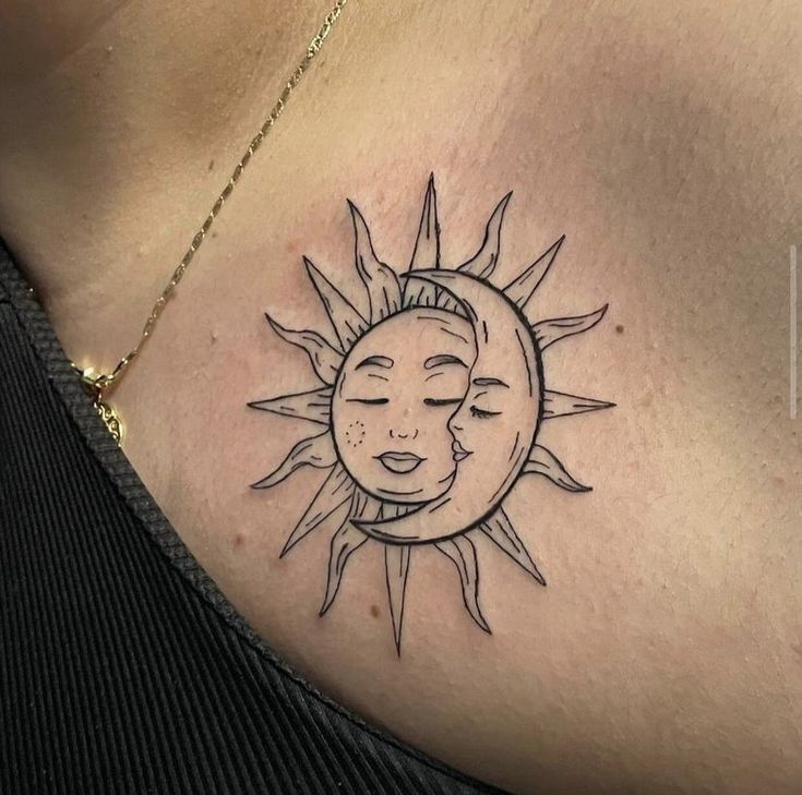 a woman's chest with a sun and moon tattoo design on the left side