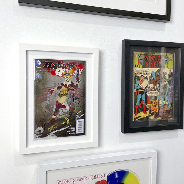 three framed comics are hanging on the wall