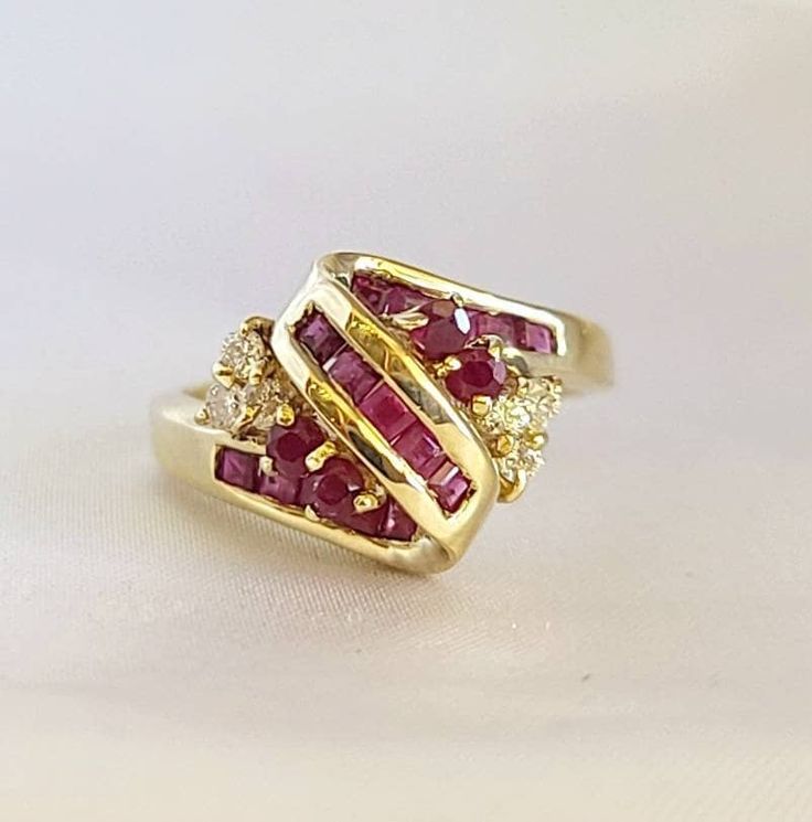 This is a cluster Ruby and diamond ring.  6 pieces of diamonds total weight 0.18 carats.  19 pieces of rubies total weight 0.85 carats.  14kt yellow gold ring weight 4.7 grams. Diamond Cluster Ruby Ring With Diamond Accents, Red Cluster Diamond Ring In 14k Gold, Cluster Yellow Gold Ruby Ring In Fine Jewelry Style, Red Diamond Cluster Ring In 14k Gold, Cluster Ruby Rings With Diamond Accents, Ruby Cluster Rings With Diamond Accents, Yellow Gold Cluster Ruby Ring, Cluster Ruby Ring In Yellow Gold, Yellow Gold Ruby Diamond Ring Stamped 14k