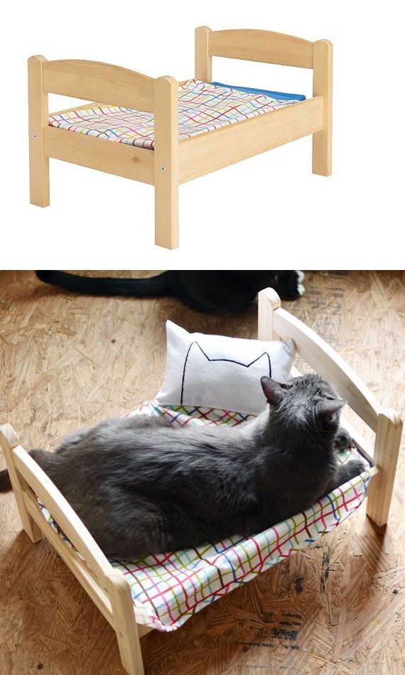 a cat laying on top of a wooden bed