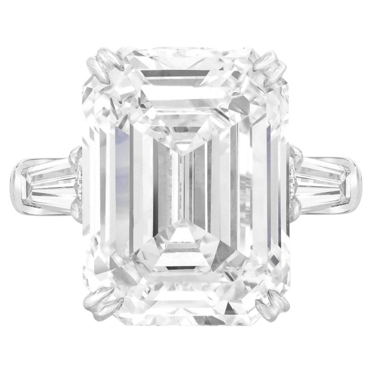 This breathtaking 10.03 ct emerald cut diamond ring exudes timeless elegance. The center stone, a GIA-certified diamond, boasts exceptional F color and VVS1 clarity, making it truly rare. Set in a sophisticated 18K White Gold band, the ring is flanked by two tapered baguette diamonds that enhance the centerpiece's brilliance. With excellent polish and symmetry, every facet reflects light to perfection. Additionally, the diamond is free of fluorescence, allowing its natural beauty to shine throug Engagement Ring Types, Emerald Cut Diamond Engagement Ring, Emerald Cut Diamond Engagement, Contemporary Engagement Rings, Emerald Cut Diamond Ring, Platinum Diamond Rings, Modern Engagement Rings, Bracelet Love, Contemporary Ring