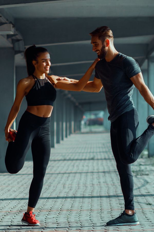 a man and woman are doing exercises together