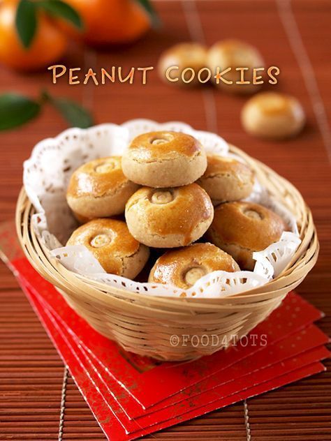 a basket filled with donuts sitting on top of a wooden table next to oranges