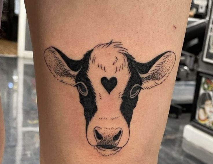 a cow's head with a heart in the middle of its forehead and nose