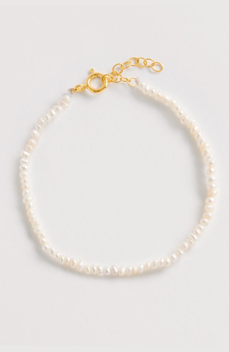 Elevate your designer jewellery collection with this beautiful Seed Pearl bracelet.  Handcrafted from luxurious 18ct Gold plated Sterling Silver and seed pearls, this lightweight statement pearl bracelet is timeless, perfect for a bride-to-be or gifting for her. A fabulous day-to-night bracelet to add a touch of glamour and style. More Details  Adjustable length bracelet made from Seed Pearls & 18ct yellow gold plated sterling silver. Maximum length: 20.5cm Minimum length: 18cm Delicate Pearl Beaded Bracelets For Formal Events, Delicate Pearl Beaded Bracelets For Formal Occasions, Delicate Pearl Beaded Bracelet For Formal Occasions, Elegant Single Strand Pearl Bracelet For Wedding, Elegant White Gold Bracelet With Pearl Chain, Timeless White Pearl Bracelet As A Gift, Timeless White Pearl Bracelet As Gift, Timeless Pearl Bracelets For Wedding, Elegant White Gold Bracelet With Pearl Drop