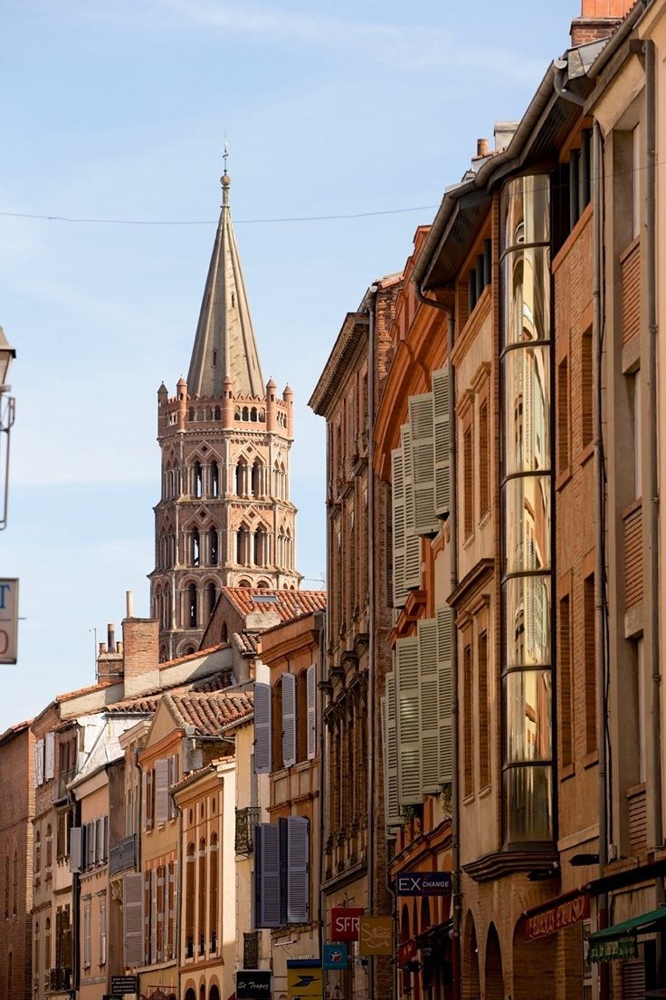 an old building with a steeple in the background