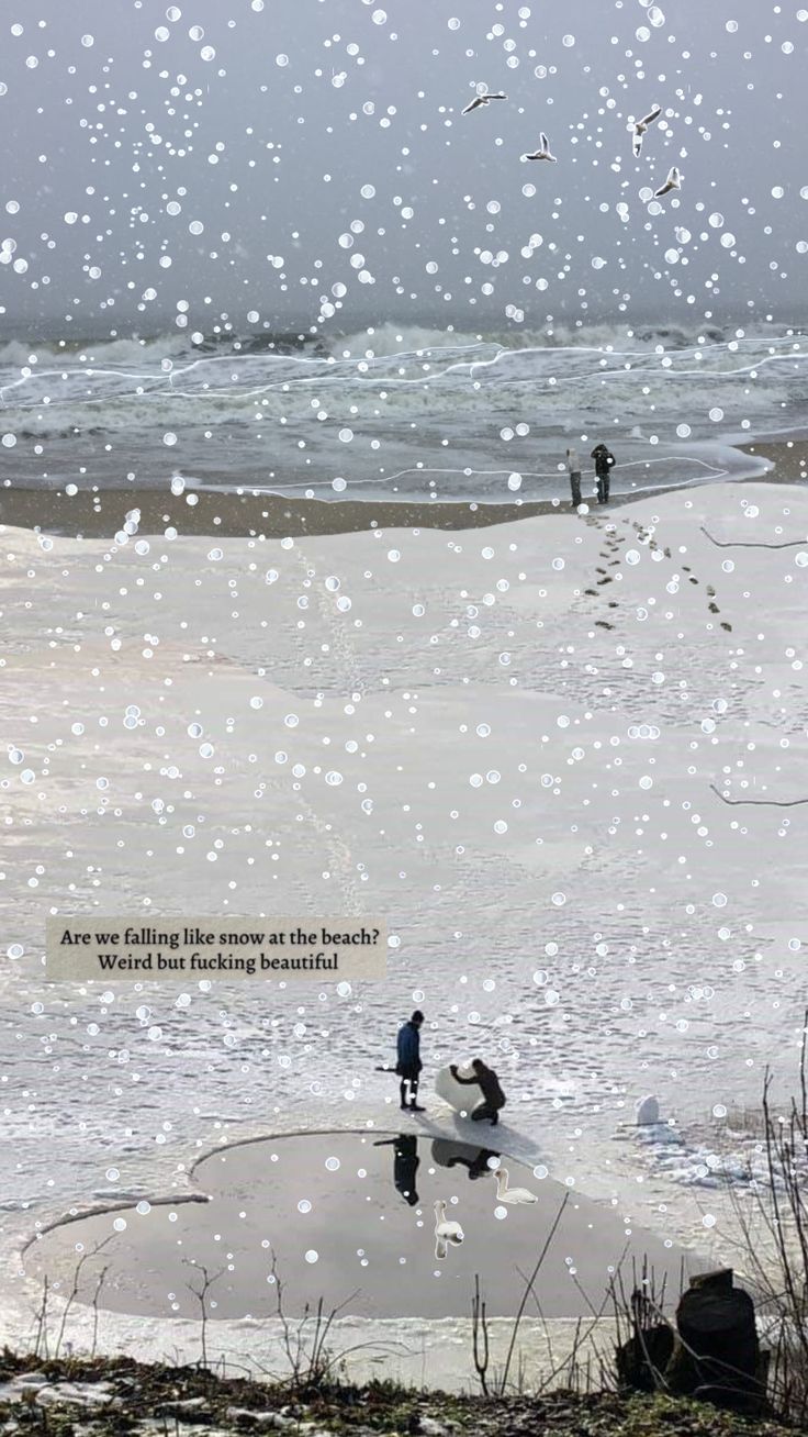 two people are standing on the beach and one is holding a surfboard in the water