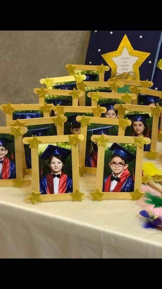 a table topped with pictures of people in graduation caps and gowns