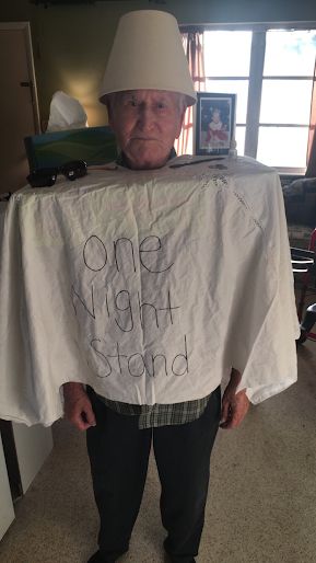 an older man wearing a white shirt with the words one night stand written on it