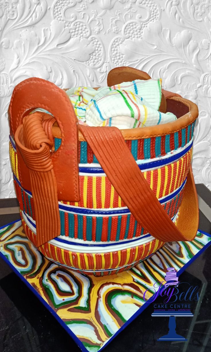 an orange ribbon is wrapped around a colorful basket