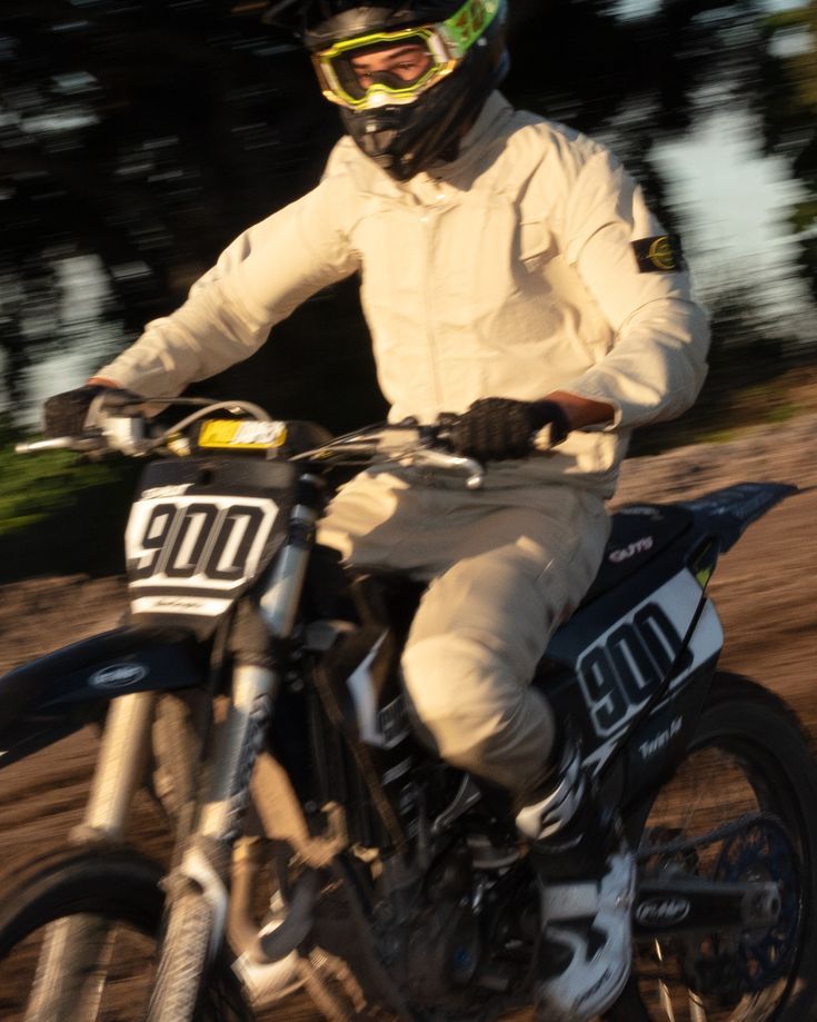 a man riding on the back of a dirt bike