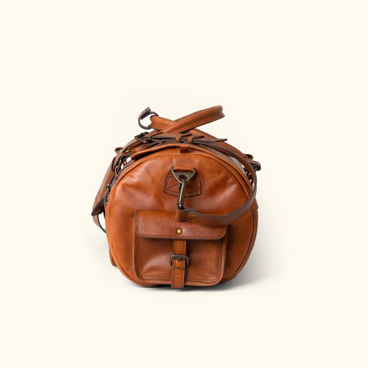 Full Grain leather travel duffle bag Luxury Leather Trim Saddle Bag For Travel, Luxury Saddle Bag With Leather Trim For Travel, Functional Leather Lined Travel Satchel, Functional Travel Satchel With Leather Lining, Functional Brown Leather Duffle Bag, Rugged Everyday Bags With Leather Trim, Functional Brown Duffle Bag With Leather Lining, Outdoor Brown Duffle Bag With Leather Handles, Brown Leather Travel Accessories