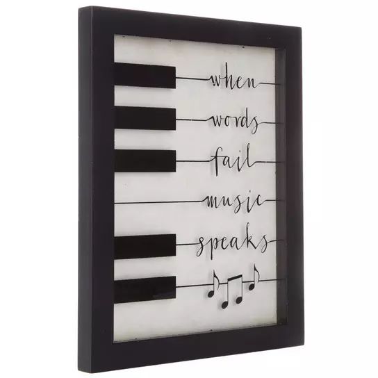 a black and white frame with musical notes on it that says when words fail music speaks