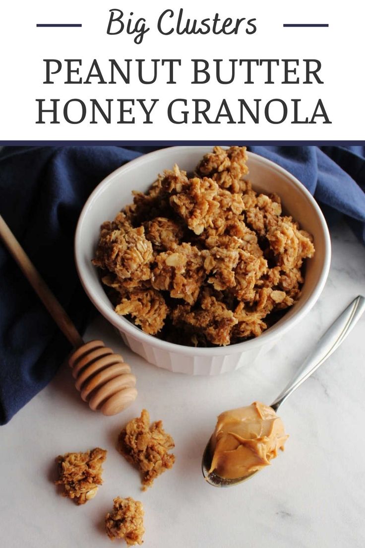 a bowl filled with peanut butter honey granola next to two spoons on a table