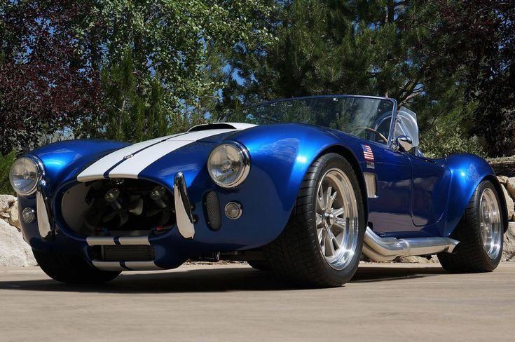 a blue and white sports car parked on the street