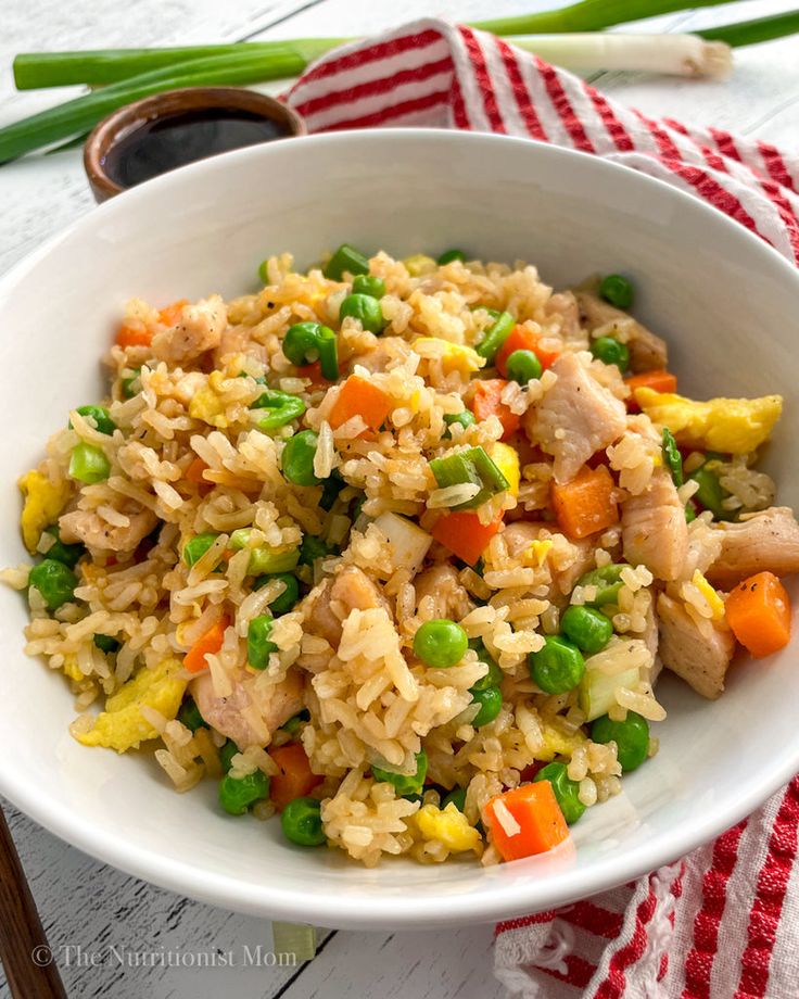 a white bowl filled with rice and vegetables