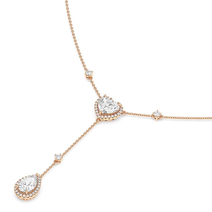 Inspired by a lariat necklace, this piece has a Y-shaped silhouette and two sparkling pendants. The chain necklace holds a heart pendant dotted at the center with a heart-cut diamond framed by a heart-shaped halo of petite round diamonds. Gently dropping from the heart pendant is a pear-cut diamond haloed by round diamonds. This necklace is a piece of everyday fine jewelry that can effortlessly enhance your daily wardrobe. Gorgeous Engagement Ring, Pear Cut Diamond, Lariat Necklace, Pear Cut, Lab Diamonds, Diamond Earrings Studs, High Quality Jewelry, Diamond Studs, Halo Diamond